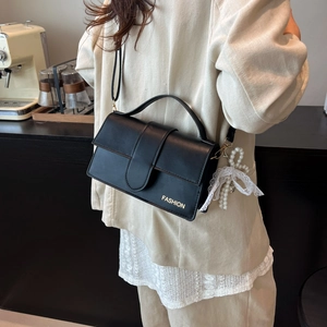 Black leather crossbody bag with fashion gold logo and pearl lace charm detail