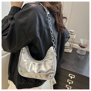 Macro detail of silver mirror hobo bag showing metallic finish and chain strap design