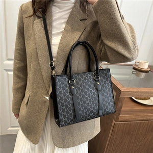 Women's chic monogram crossbody bag with M-pattern design and adjustable strap