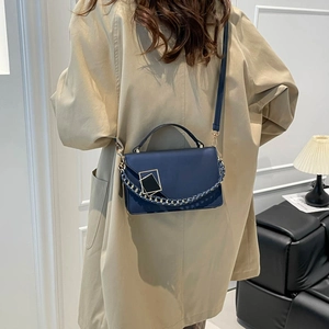 Navy blue minimalist leather crossbody bag with gold chain detail and square hardware