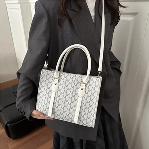 White monogram crossbody square bag with gold hardware and adjustable strap