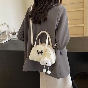 Sac bandoulière carré minimaliste blanc cassé avec papillon argenté et breloque en peluche