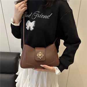 Retro brown leather underarm bag with a gold petal lock shown on a model for daily style