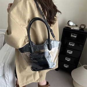 Minimalist transparent PVC bucket bag with black inner pouch shown in a lifestyle setting