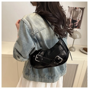 Y2K style black glossy leather shoulder bag with double silver metal buckles on a model