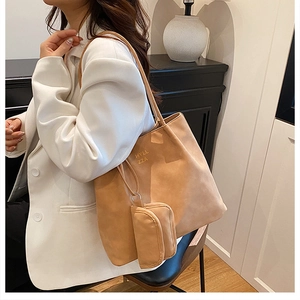 Detail of caramel faux suede tote bag with small zipper pouch and branded lettering