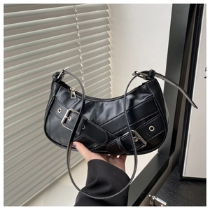Detailed view of black PU leather baguette bag with silver metal buckles and retro rock style