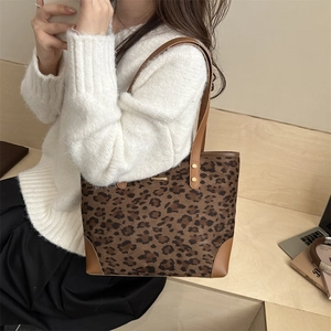 Retro leopard print tote bag with brown leather trim shown from a 45-degree angle view