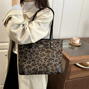 Fashionable leopard print tote bag for women with black leather straps and gold metal plaque