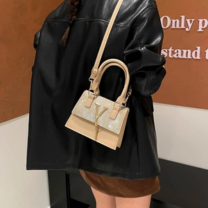 Fashionable beige mini crossbody bag with sequined flap and golden V logo pendant