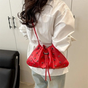 Red studded bucket bag with drawstring closure and silver rivets for women