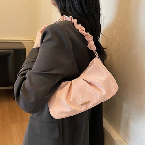 Pink ruched cloud shoulder bag with ruffle strap and metallic logo in a stylish design