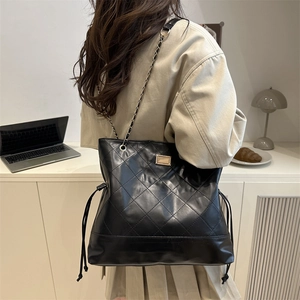 Vintage black quilted chain tote bag with drawstring detail for women's daily commute
