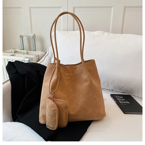 Detail of camel faux suede tote bag set with small pouch and HYLL ZZA lettering
