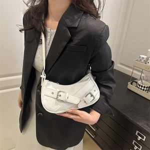 White crescent underarm bag with silver metal buckles and adjustable leather shoulder strap