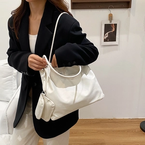 Minimalist white faux leather tote bag with matching small pouch for women daily use