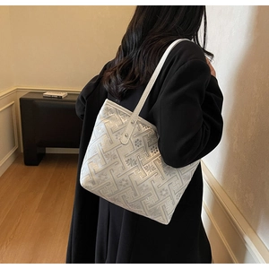 Detail of elegant white tote bag featuring intricate jacquard floral and geometric patterns