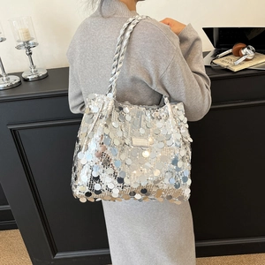 Silver sequined large tote bag with woven handles and fashion-forward metallic shine