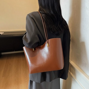 Glossy brown leather tote bag with gold hardware for women, minimalist workwear style