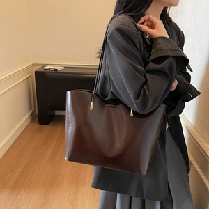Chic dark brown faux leather tote bag with gold metal accents for women commute