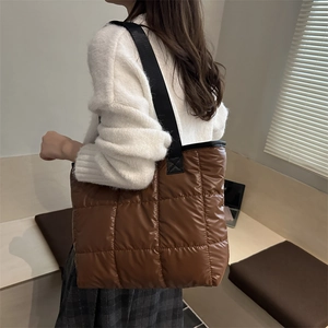 Brown quilted puffer tote bag with glossy finish shown in a stylish autumn lifestyle setting