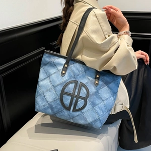 Blue denim quilted tote bag with black leather straps and large capacity for women