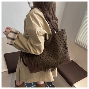 Detail of dark brown knitted tote bag featuring stylish fringe and leopard print accents
