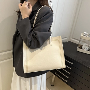Minimalist beige tote bag with litchi texture and shoulder strap for casual work style