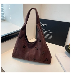Detailed texture of dark brown faux suede tote bag with laser-cut floral patterns