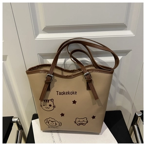 Detail of khaki bucket bag with cute cat prints and adjustable brown shoulder strap
