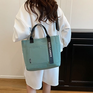 Versatile mint green canvas tote bag for lunch boxes with a detachable shoulder strap