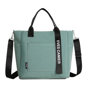 Mint green canvas lunch tote bag with adjustable shoulder strap and sport label
