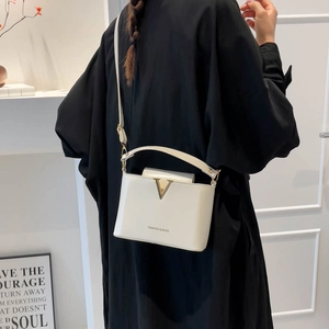Chic white structured crossbody bag with gold hardware and top handle for women