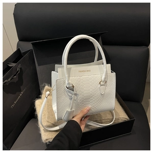 Crocodile-embossed white leather bag in premium gift box with gold logo detailing