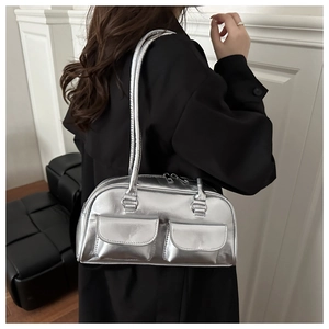 Detail of a shiny silver metallic bowling bag with symmetrical front flap pockets