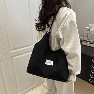 Minimalist black canvas tote bag for women with fashion original design woven label