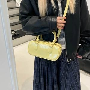 Yellow glossy patent leather square crossbody bag with gold hardware and top handle