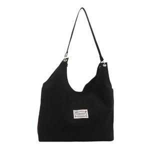 Minimalist black canvas tote bag with fashion tag and spacious hobo shoulder strap