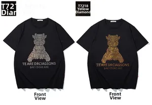 Detail of black cotton T-shirts with shiny geometric rhinestone bear patterns in gold and silver