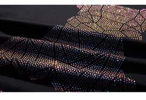 Macro detail of high-quality colorful rhinestones on premium black knit cotton t-shirt fabric