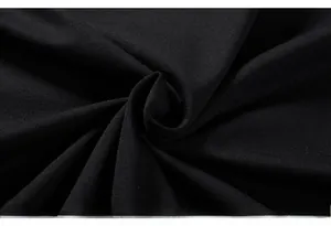 Close-up of premium black knitted cotton fabric texture with soft elastic folds