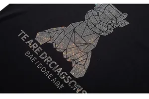 Detailed close-up of geometric bear rhinestone pattern on black cotton t-shirt
