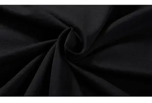Macro shot showing the fine texture and high-quality knit of the black cotton fabric