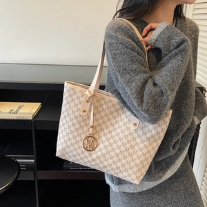 Chic monogram tote bag for women with gold M pendant, stylish ivory shoulder bag