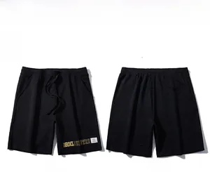 Vue avant et arrière du short en coton noir avec cordon de serrage et imprimé jaune
