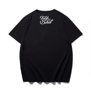 Black oversized T-shirt with white Fresh Baked print and red side label on a white background