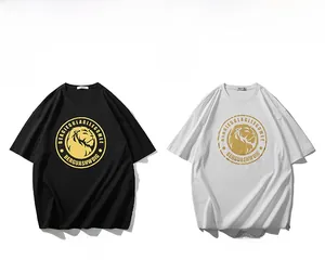 Detailed flat lay of oversized cotton T-shirts with golden lion head logo in black and white