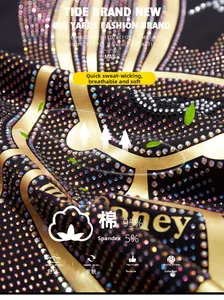 Close-up of premium 95% cotton fabric with gold lettering and colorful rhinestones