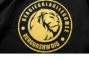Macro detail of the golden lion emblem print on black knit fabric of an oversized t-shirt
