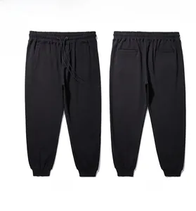 Detail of black sports joggers featuring an adjustable drawstring and elastic waistband